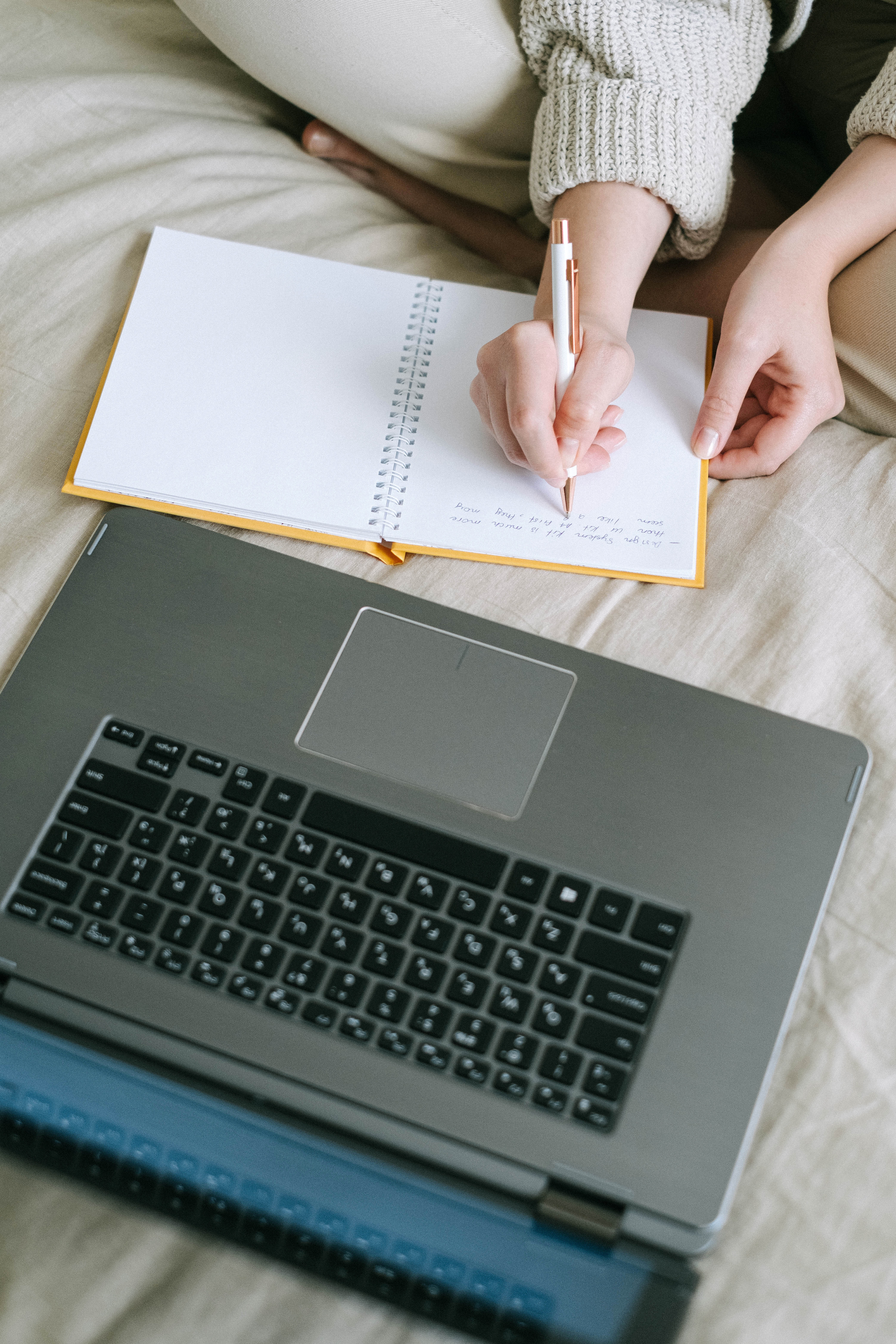 A Person Writing in a Notebook